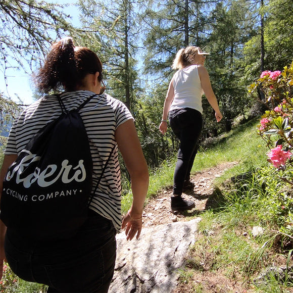 HIking up a mountain with guests in the Pre-Alps with a view of Lake Como and the valley below.