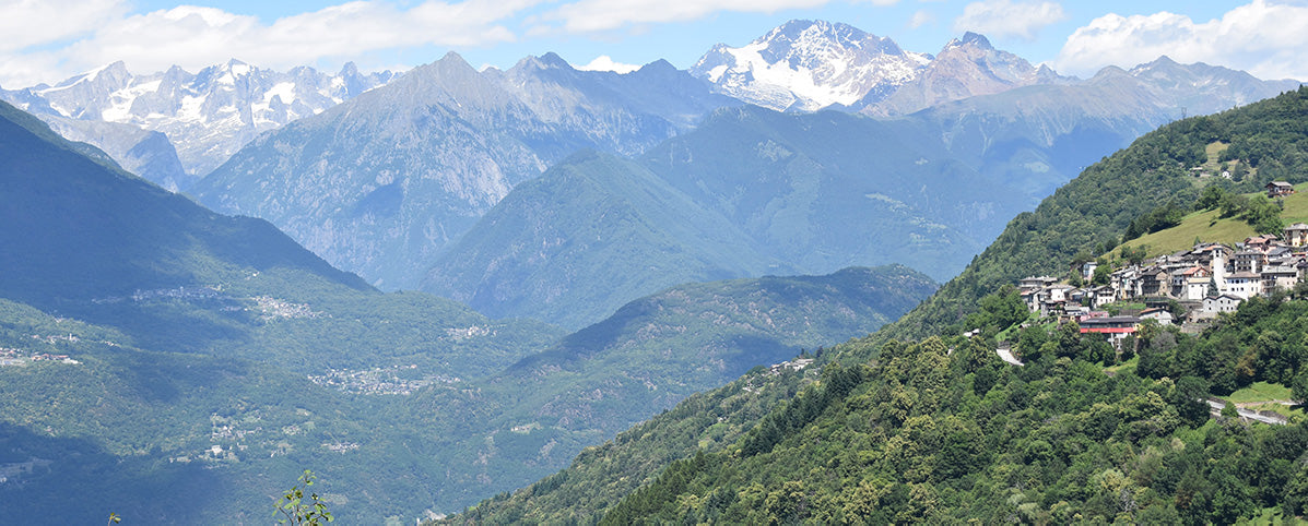 View of Lake Como and the Pre-Alps from a Hiking Trail with small mountain town nestled across the valley